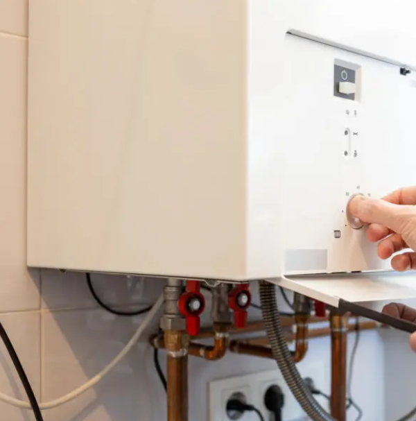 Wall-mounted tankless water heater with copper piping and valves
